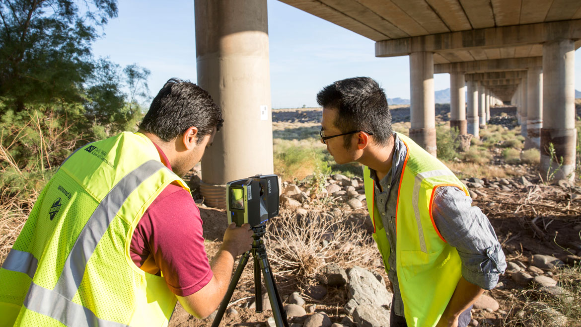 Pingbo Tang and his graduate student collect data near Tempe Town Lake