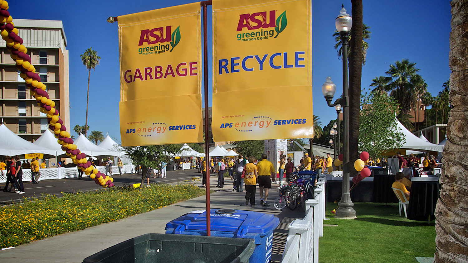 An outdoor ASU event is pictured, with ASU's special garbage and recycling containers in view.