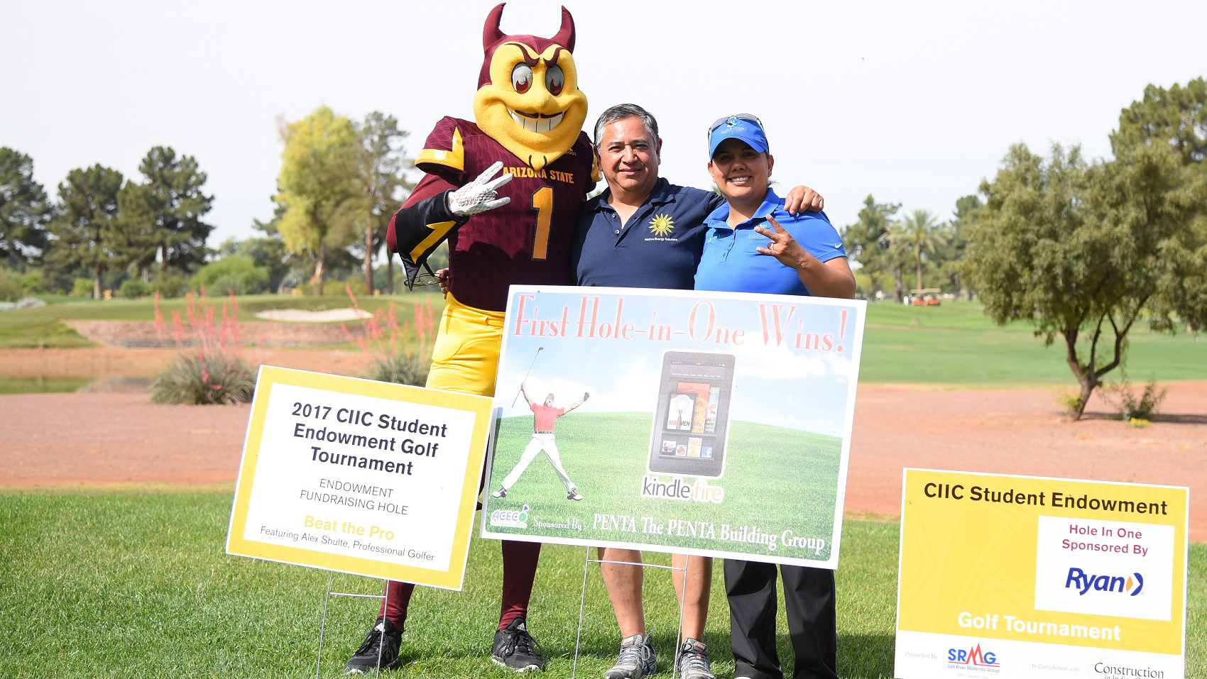ASU's Sun Devil mascot, Sparky, stands with two sponsors at the CIIC Golf tournament