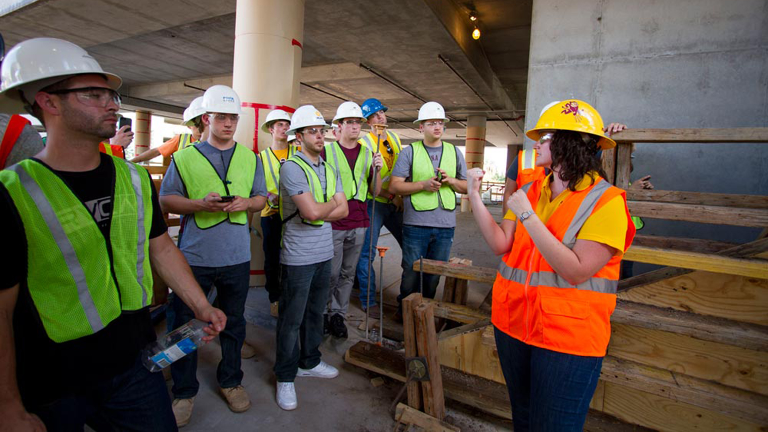 Kristen Parrish, graduate program chair for construction management, leads a group of students at the CAVC construction site
