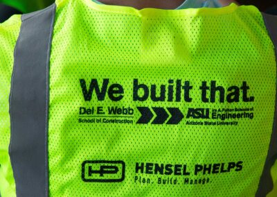 Construction vest with "We built that." logo and sponsorship by Hensel Phelps